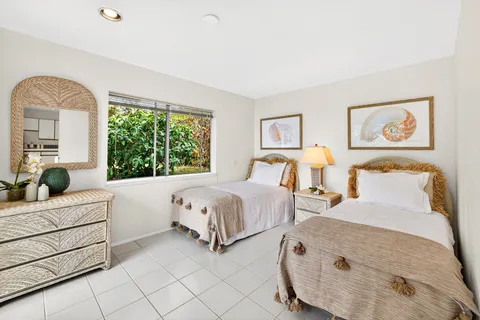 a bedroom with 2 bed and window