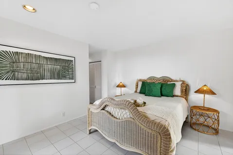 a bedroom with a bed and a painting on the wall