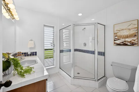 a spacious bathroom with a shower sink and toilet