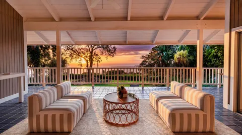 a balcony with furniture and a potted plant