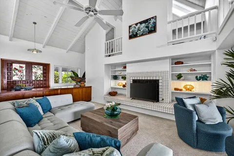 a living room with furniture a fireplace and a flat screen tv