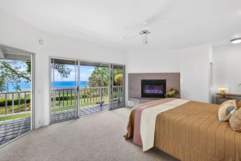 a spacious bedroom with a bed and a tv