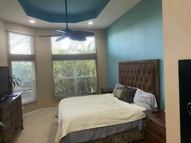 a bedroom with a large bed and a chandelier