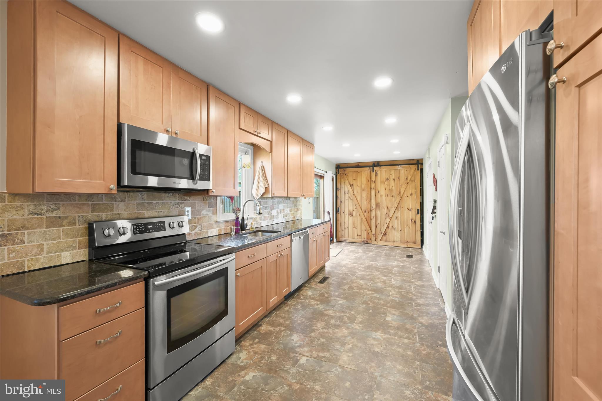 14821 Ridge Oak Drive Boyds, MD 20841 - Photo 4 of 49 a large kitchen with stainless steel appliances granite countertop a refrigerator a stove a sink and a microwave