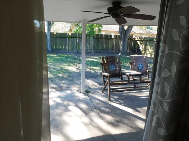 a view of a porch with chairs and backyard