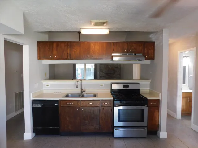 a kitchen with a stove and a sink