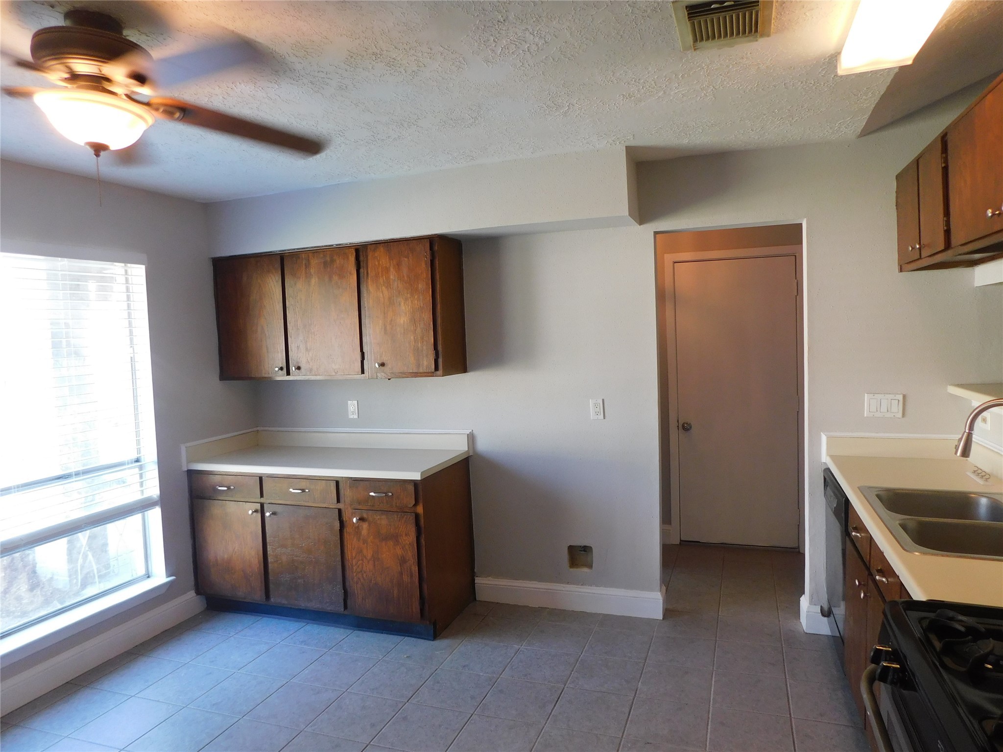 3014 Windemere Drive Pearland, TX 77584 - Photo 9 of 19 a kitchen with stainless steel appliances a stove a sink and a refrigerator