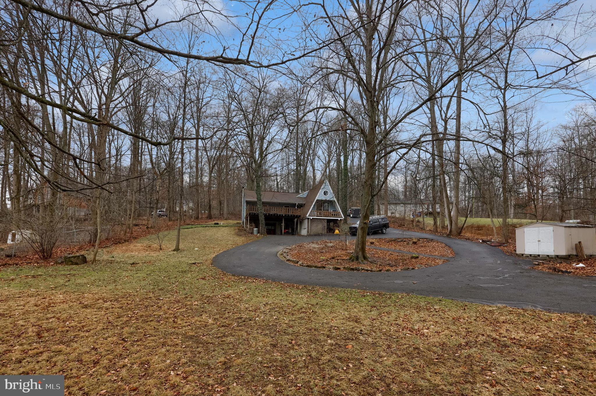 460 Greenville Road Denver, PA 17517 - Photo 36 of 50 a view of a fire pit with large trees