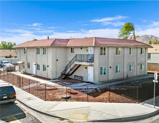 a view of a house with a wooden deck