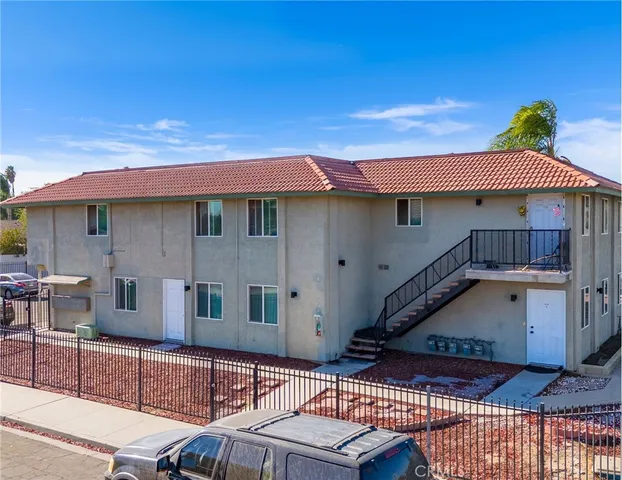 a view of a patio with furniture and a fire pit