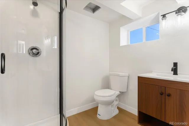 a white toilet sitting next to a bathroom sink