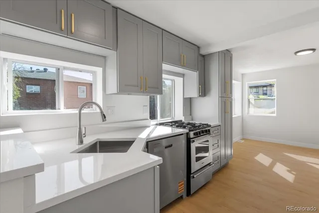 a kitchen with stainless steel appliances granite countertop a sink stove and refrigerator