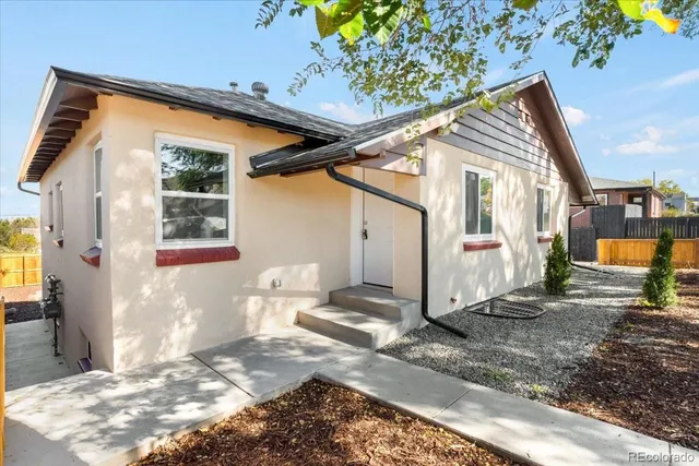 a front view of a house with wooden fence