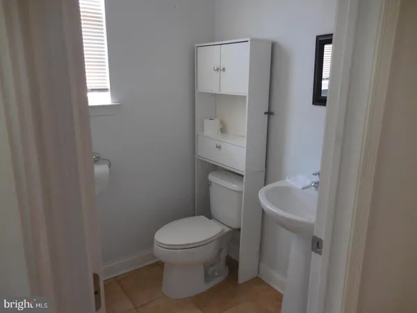a white toilet sitting next to a bathroom sink