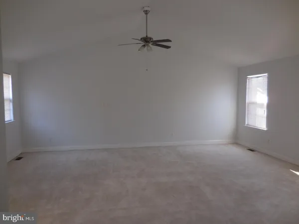 a view of an empty room and a window
