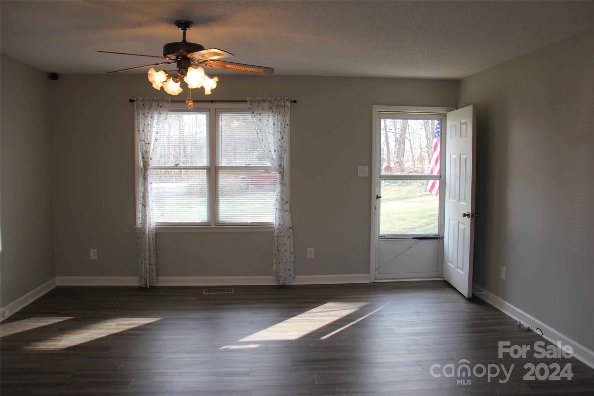 147 Sinclair Road Mooresville, NC 28115 - Photo 16 of 30 an empty room with wooden floor and windows