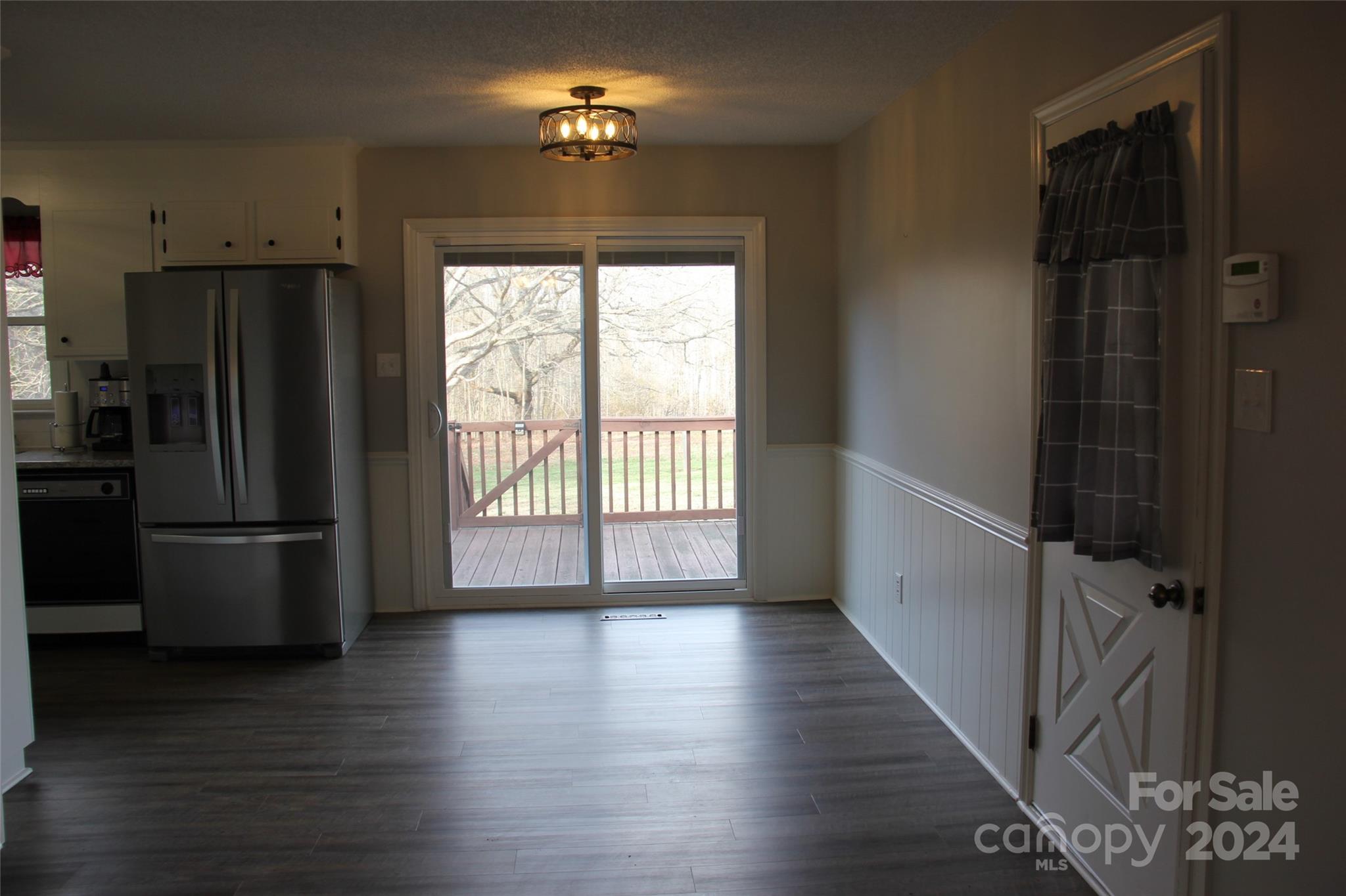 147 Sinclair Road Mooresville, NC 28115 - Photo 18 of 30 a view of a refrigerator in kitchen and wooden floor