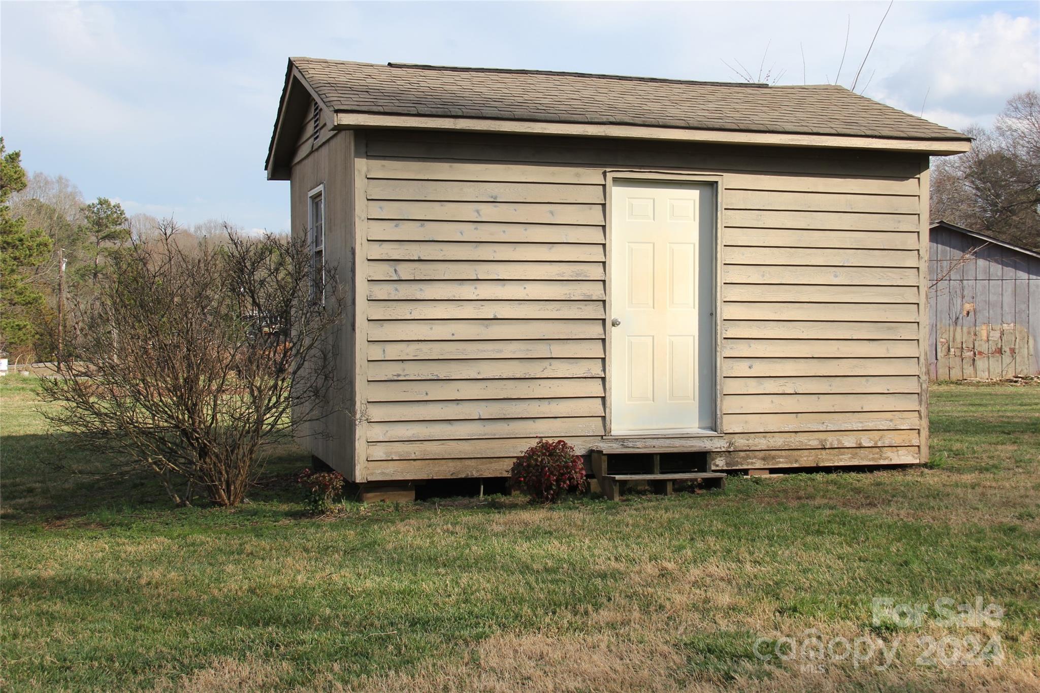 147 Sinclair Road Mooresville, NC 28115 - Photo 19 of 30 a small white house with a white roof and yard
