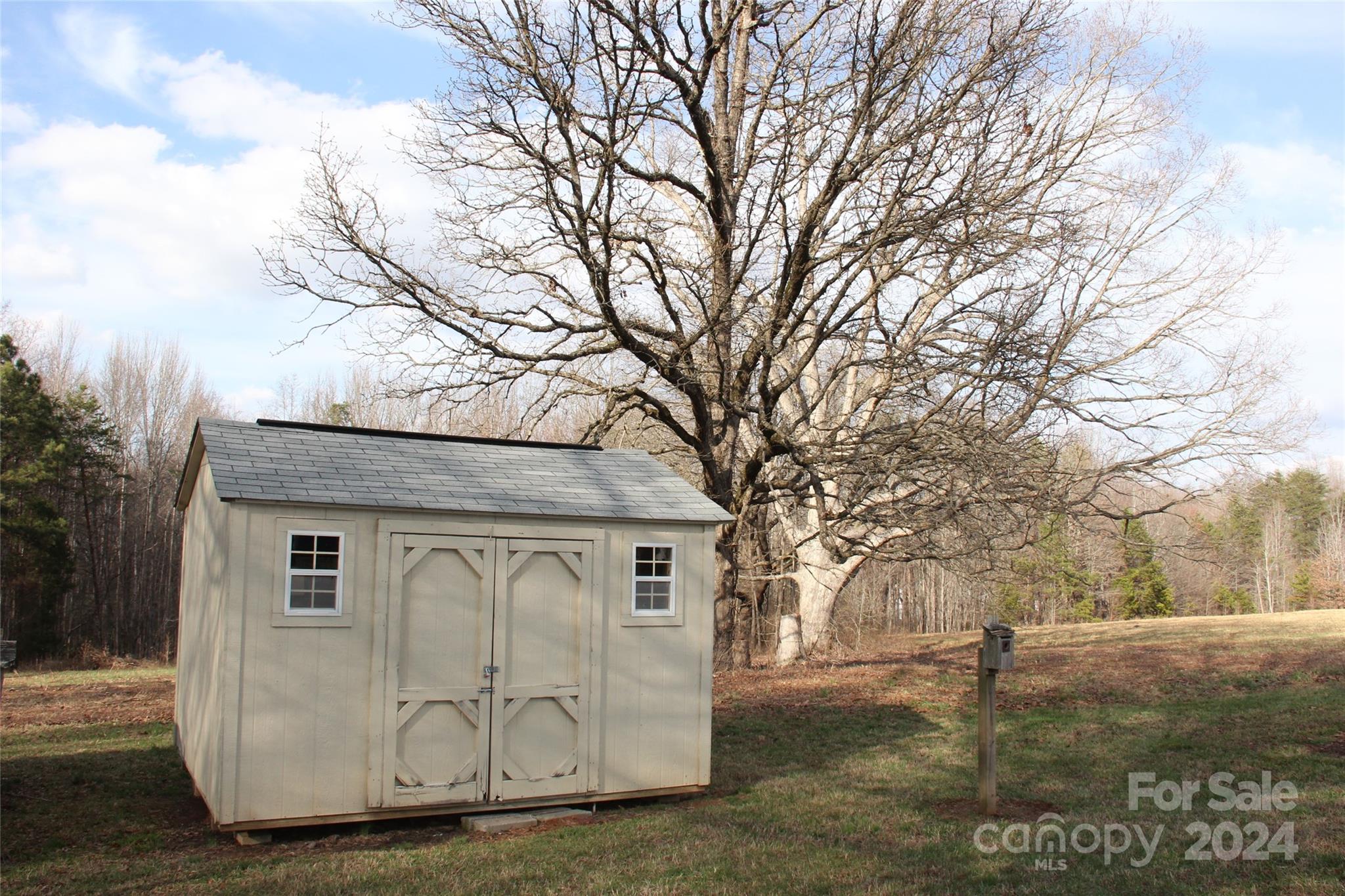 147 Sinclair Road Mooresville, NC 28115 - Photo 22 of 30 a view of a tiny house with a large tree