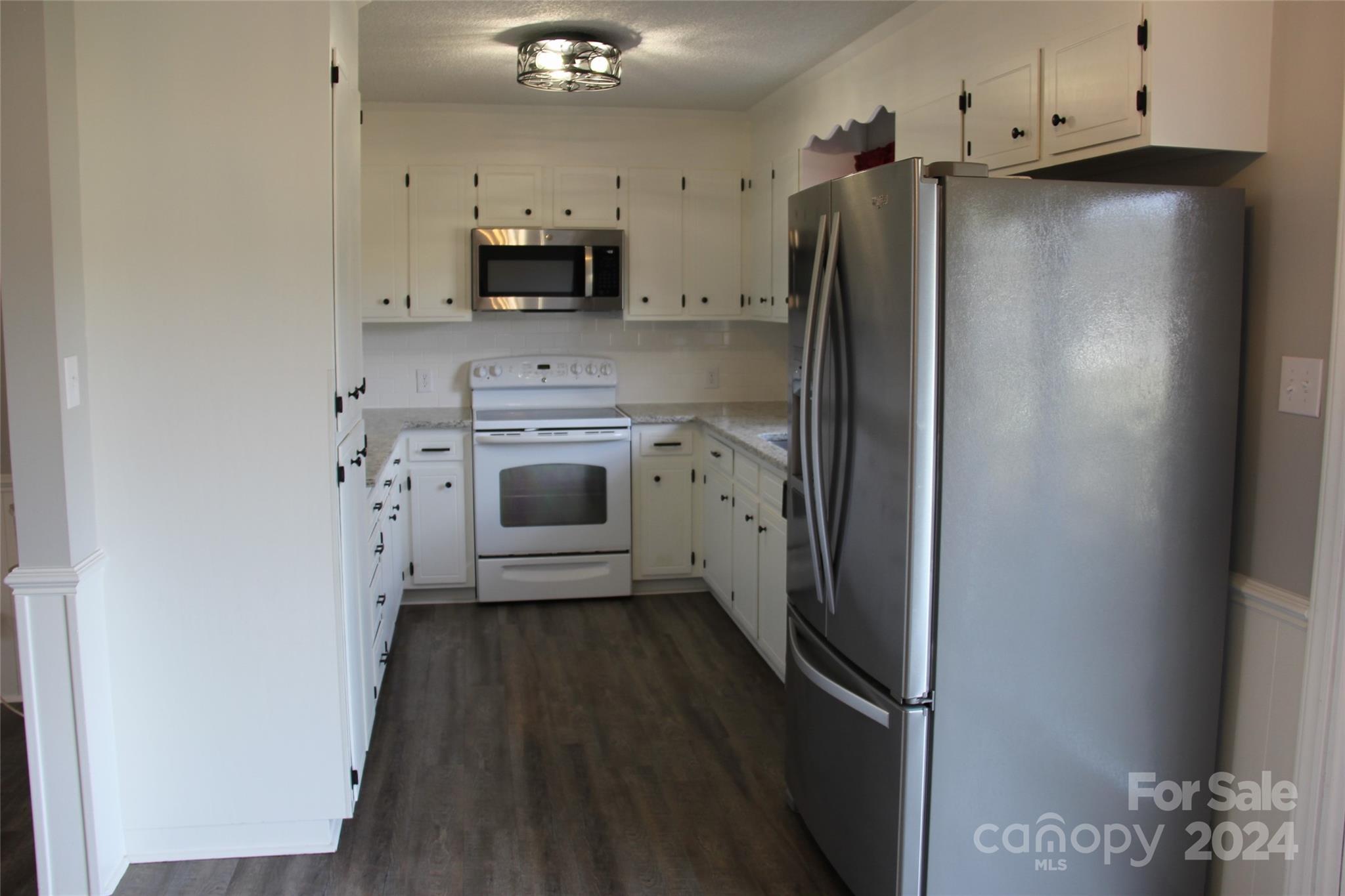 147 Sinclair Road Mooresville, NC 28115 - Photo 8 of 30 a kitchen with stainless steel appliances a refrigerator sink and stove