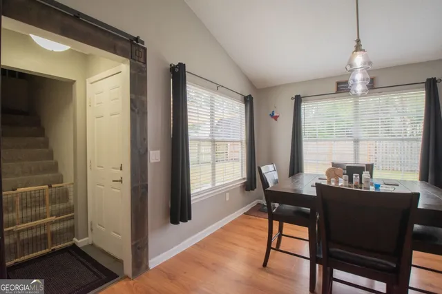 a dining room with furniture and window