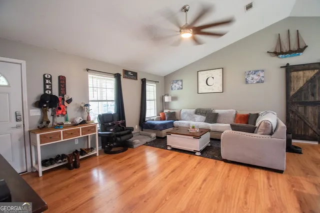 a living room with furniture window and a wooden floor