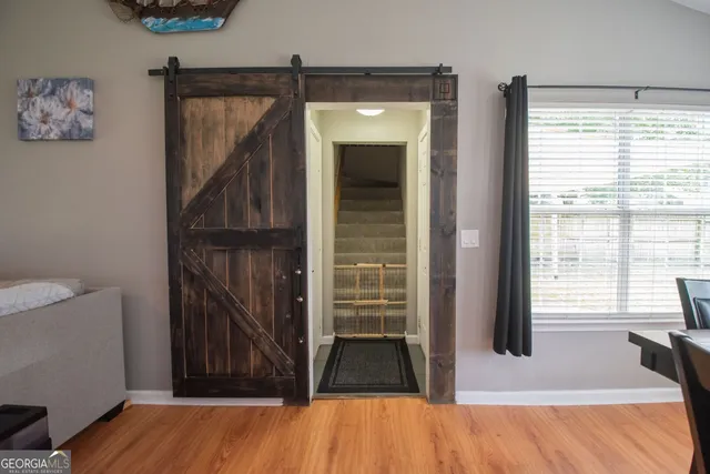 a view of a room with wooden floor and a ceiling fan
