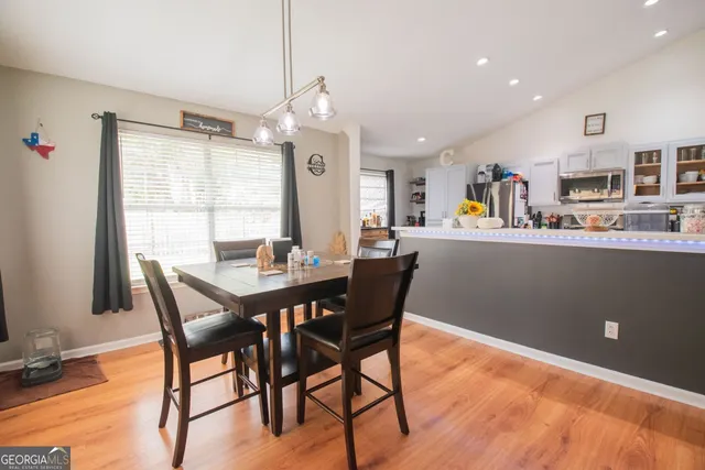 a view of a dining room with furniture window and wooden floor