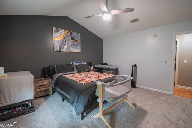 a bedroom with a bed a desk and chair