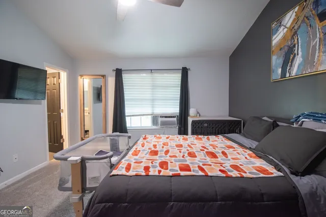 a bedroom with a bed and window