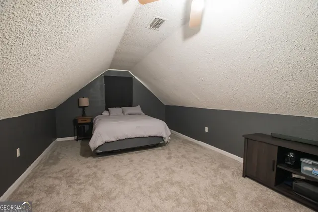 a bedroom with a bed and a night stand