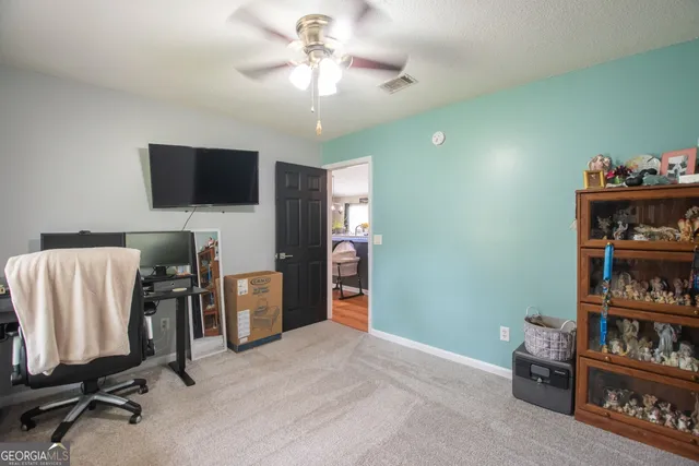 a view of a livingroom with furniture and a flat screen tv