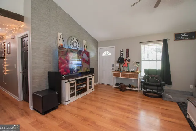 a living room with furniture and a flat screen tv
