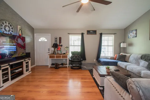 a living room with furniture and a flat screen tv