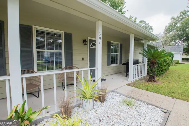 a view of a chair and table in a backyard