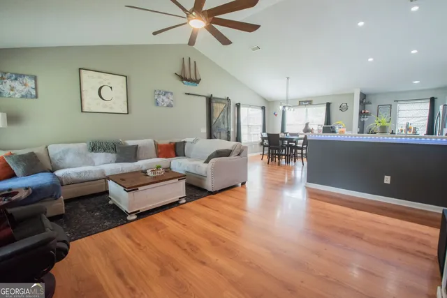 a living room with furniture and a wooden floor
