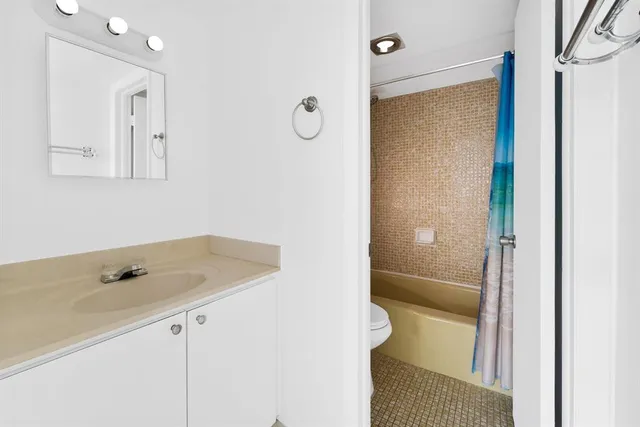 a bathroom with a tub sink and vanity