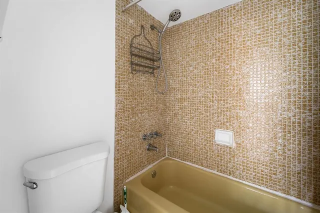 a bathroom with a bathtub and shower