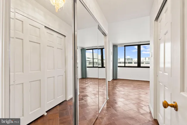 an empty room with windows and closet