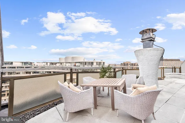 a view of a swimming pool with a couches and lounge chairs