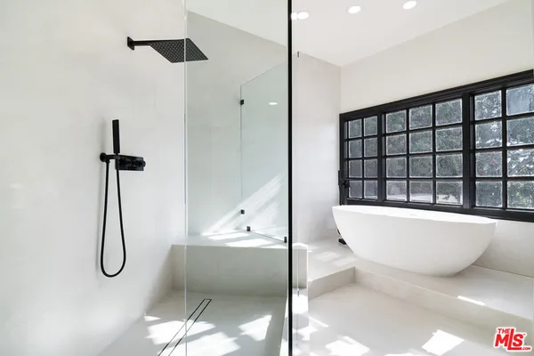a bathroom with a bathtub and a shower