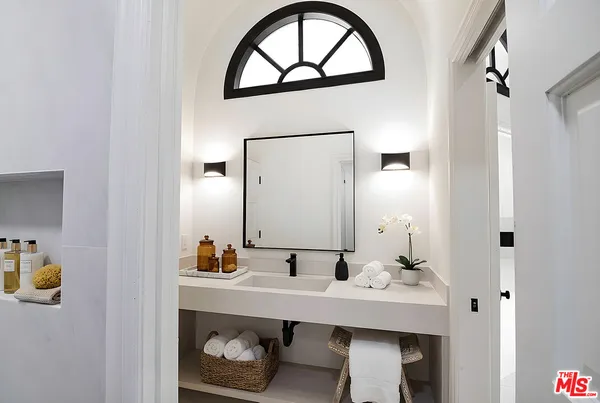 a bathroom with a sink a mirror and vanity