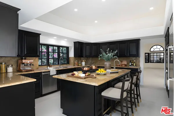 a kitchen with stainless steel appliances kitchen island granite countertop a sink and cabinets