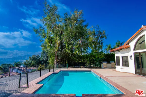 a view of a backyard with swimming pool