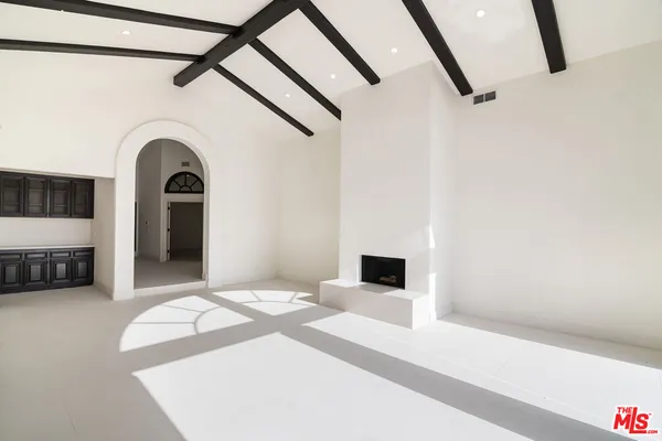 a spacious bedroom with a bed and a view of bathroom