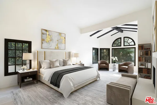 a spacious bedroom with a bed and a large window