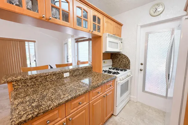 a kitchen with stainless steel appliances granite countertop a stove and a refrigerator