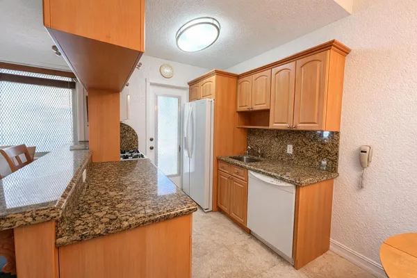 a kitchen with a stove and a refrigerator