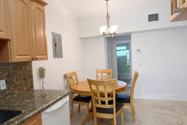 a view of a dining room with furniture and chandelier