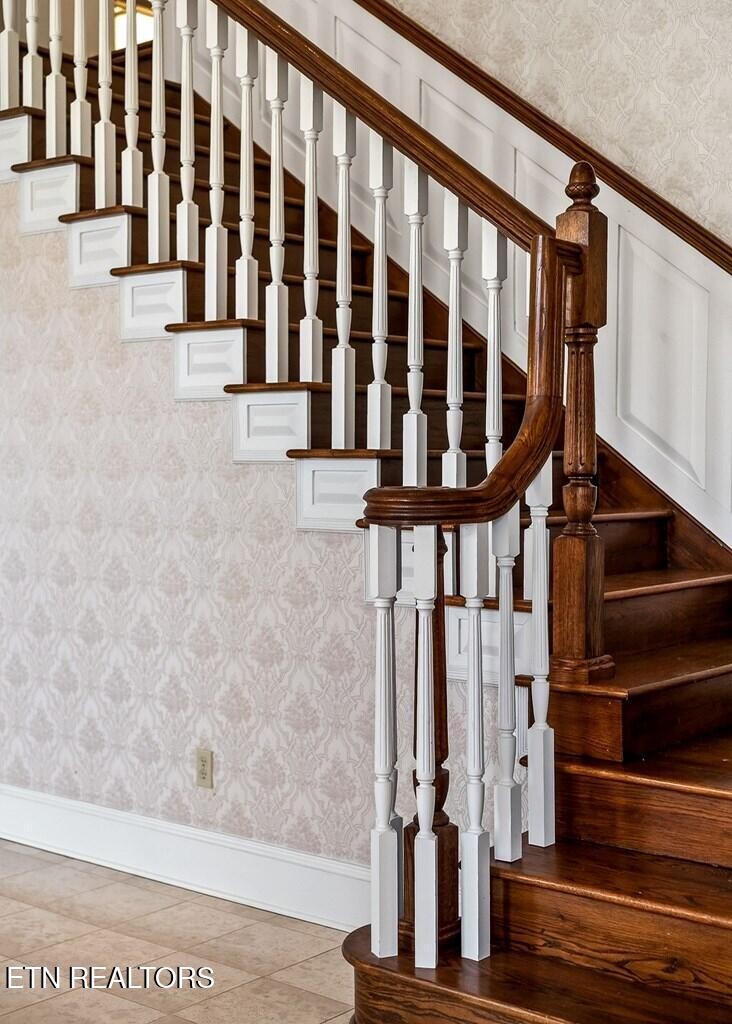 6211 Rocky Point Road Cookeville, TN 38506 - Photo 20 of 59 a view of staircase with lots of frames on wall and a window